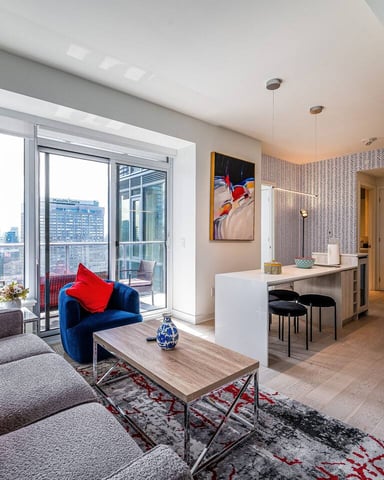 Bright Toronto condo living room with floor-to-ceiling windows and city views